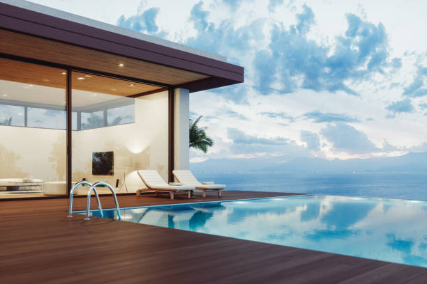 Modern luxury villa exterior with infinity pool and beautiful ocean view at dawn. - bali construction company